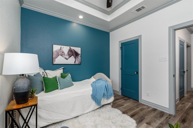 bedroom with wood-type flooring and ornamental molding