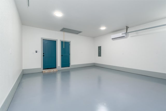 garage with electric panel and a wall mounted AC