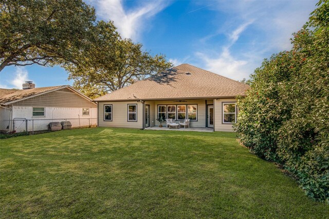 rear view of property featuring a patio area, ceiling fan, and a yard