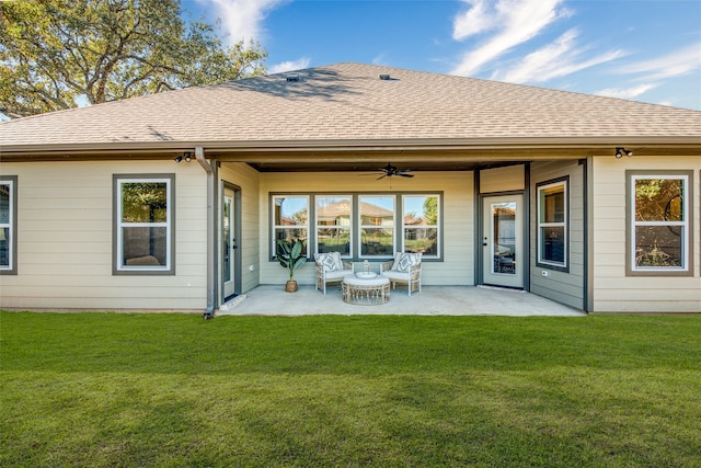 back of property with ceiling fan, a yard, and a patio