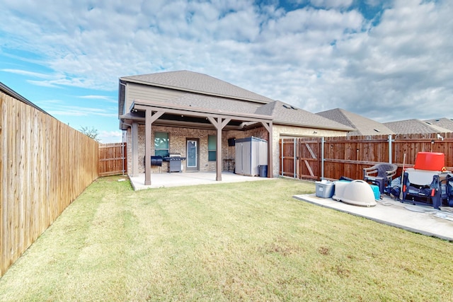 rear view of property featuring a patio and a yard