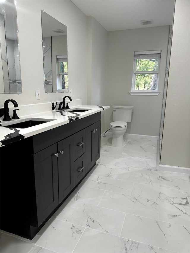 bathroom featuring toilet and vanity