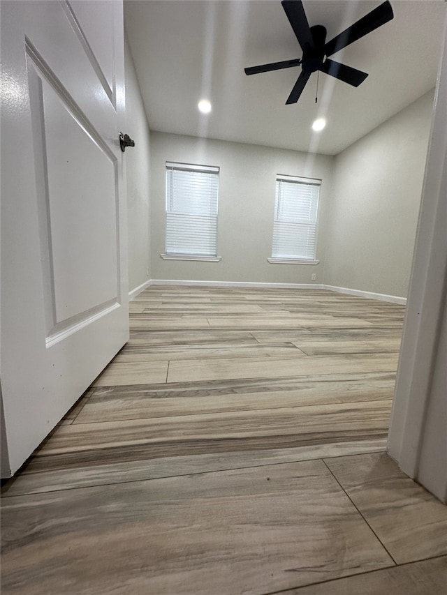 unfurnished room featuring light hardwood / wood-style floors and ceiling fan