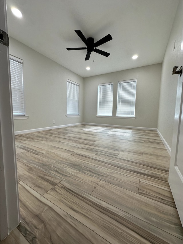 unfurnished room featuring ceiling fan and light wood-type flooring