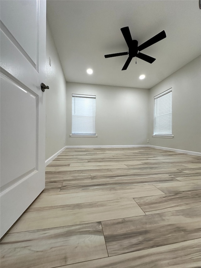 unfurnished room featuring ceiling fan and a wealth of natural light