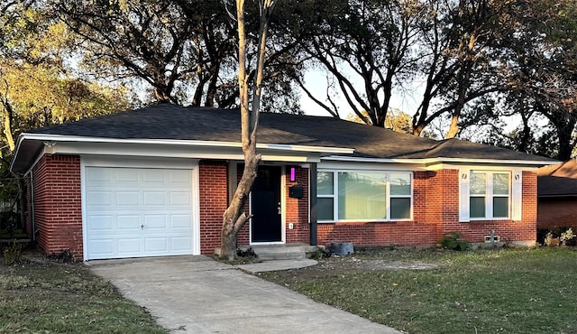 ranch-style house featuring a front lawn and a garage