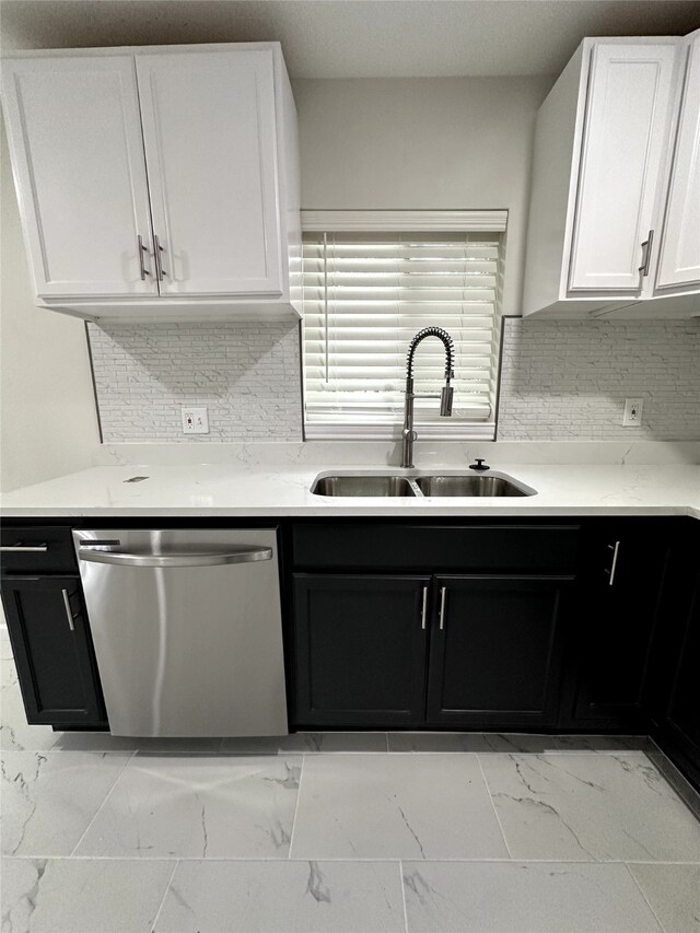 kitchen with decorative backsplash, dishwasher, white cabinets, and sink