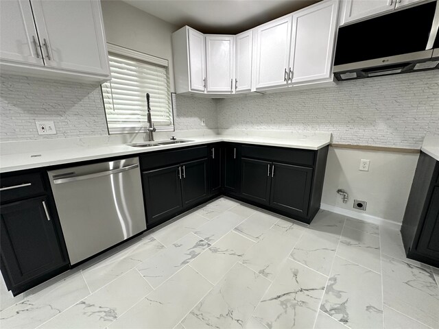 kitchen with dishwasher, white cabinets, tasteful backsplash, and sink