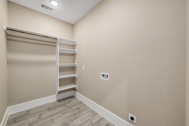 2801 Beechwood St, Granbury, TX 76048 - washroom featuring hookup for an electric dryer, light wood finished floors, washer hookup, and baseboards