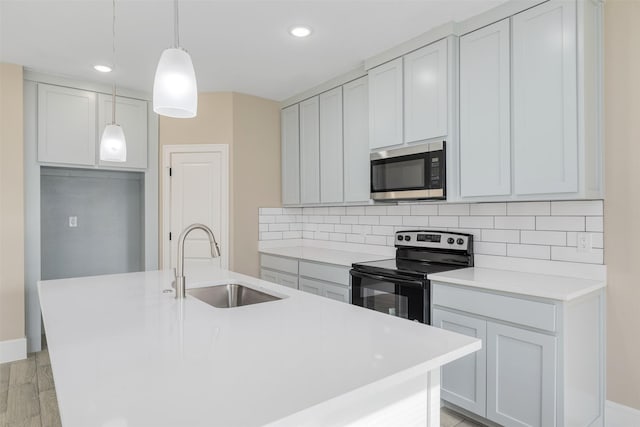 2801 Beechwood St, Granbury, TX 76048 - kitchen with stainless steel microwave, electric range oven, a sink, tasteful backsplash, and recessed lighting
