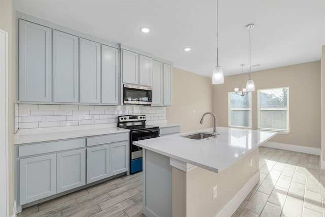 2801 Beechwood St, Granbury, TX 76048 - kitchen featuring range with electric cooktop, stainless steel microwave, a sink, backsplash, and light countertops
