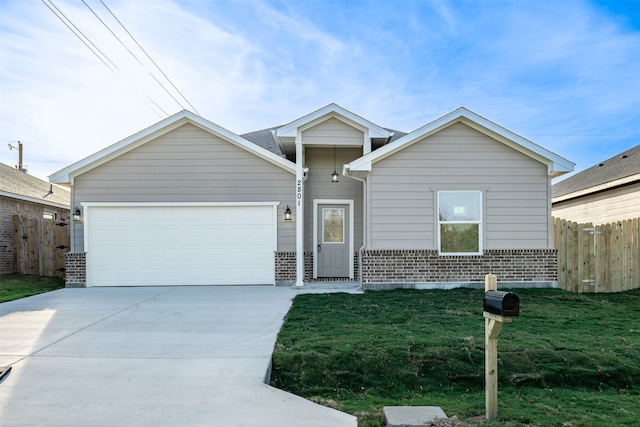 view of front of home featuring a front yard and a garage