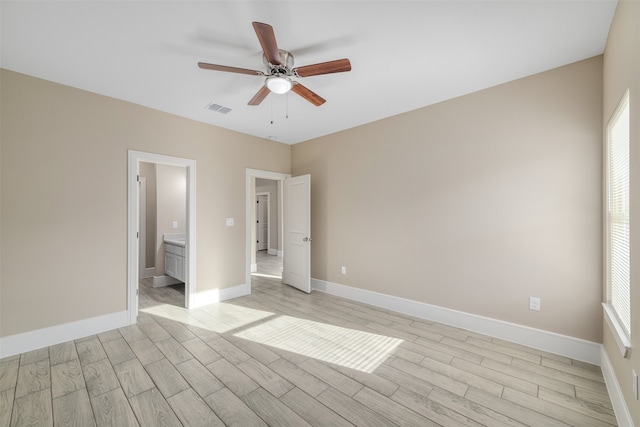 empty room with ceiling fan and light wood-type flooring