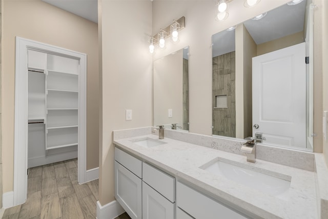 bathroom featuring vanity, wood-type flooring, and a shower with door