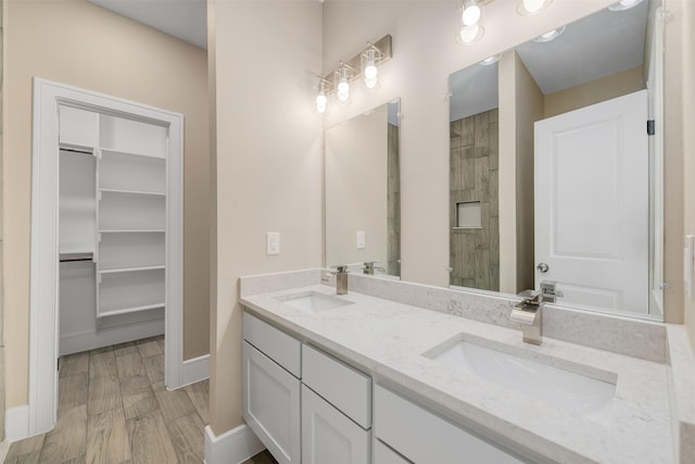 2801 Beechwood St, Granbury, TX 76048 - full bath featuring double vanity, a tile shower, baseboards, and a walk in closet