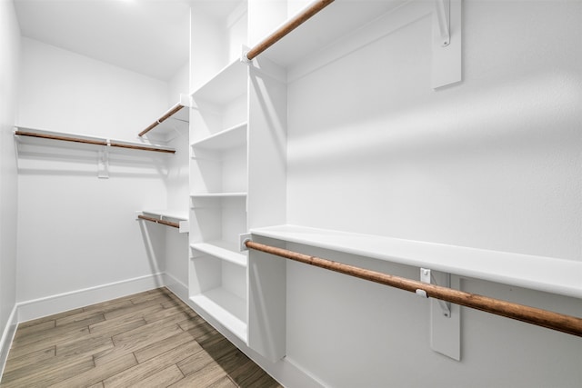 walk in closet featuring light hardwood / wood-style flooring