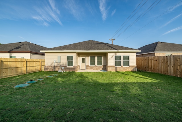 rear view of house with a lawn