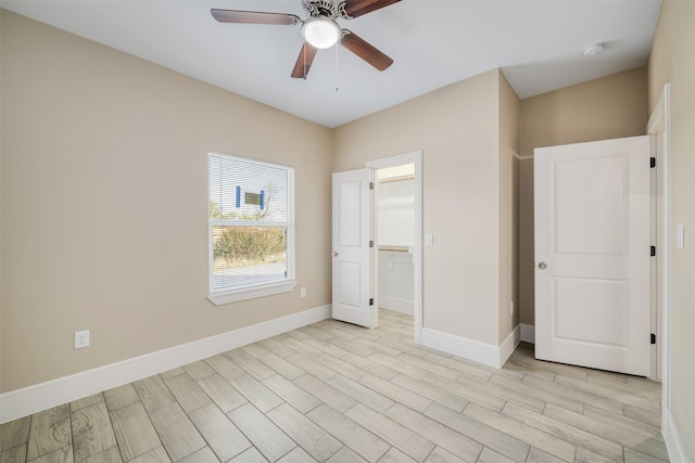 2801 Beechwood St, Granbury, TX 76048 - unfurnished bedroom with baseboards, light wood-type flooring, a ceiling fan, and a walk in closet