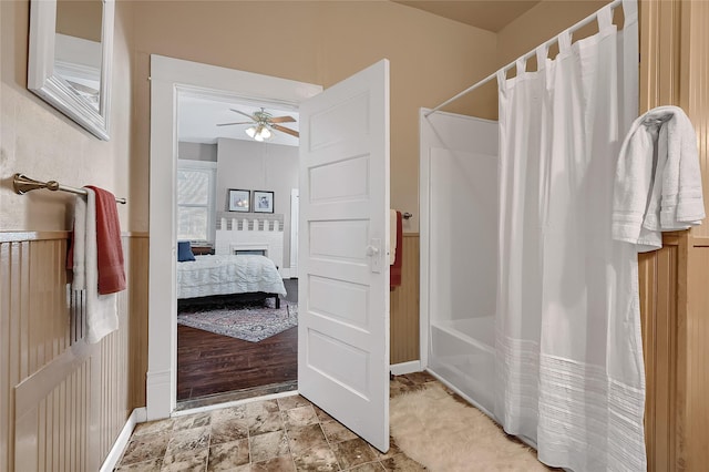 bathroom featuring ceiling fan and shower / bath combo with shower curtain