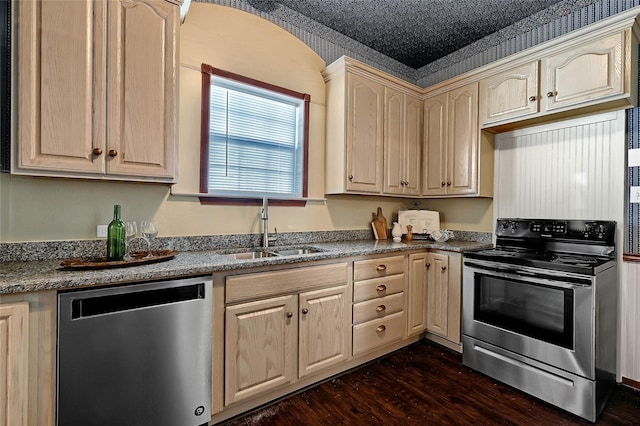 kitchen featuring appliances with stainless steel finishes, sink, light brown cabinets, and dark hardwood / wood-style floors