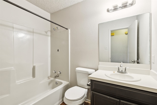 full bathroom with toilet, vanity, a textured ceiling, and tub / shower combination