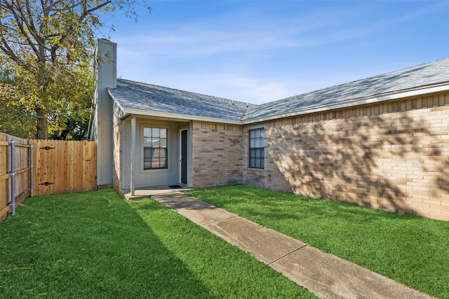 doorway to property with a lawn