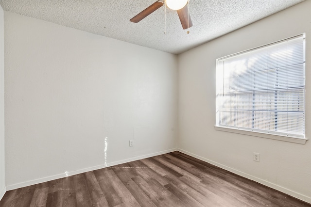 spare room with ceiling fan, dark wood-type flooring, and a textured ceiling