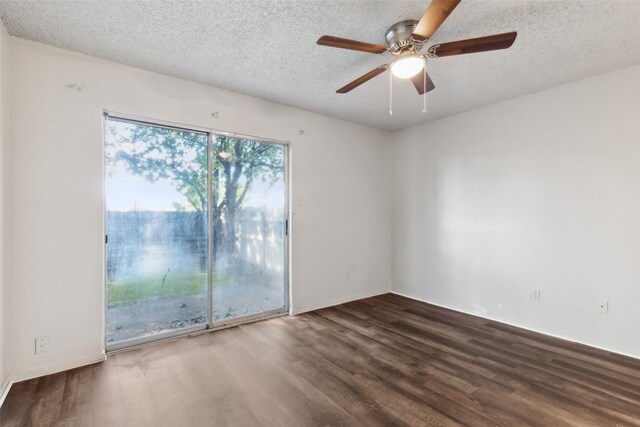 spare room with a textured ceiling, dark hardwood / wood-style floors, and ceiling fan