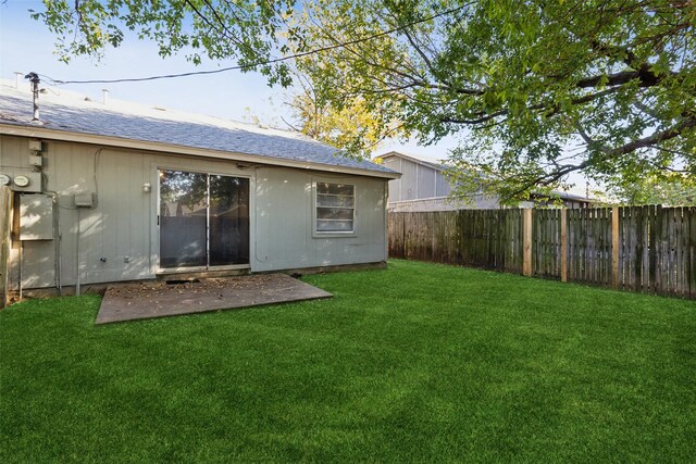 rear view of house featuring a lawn