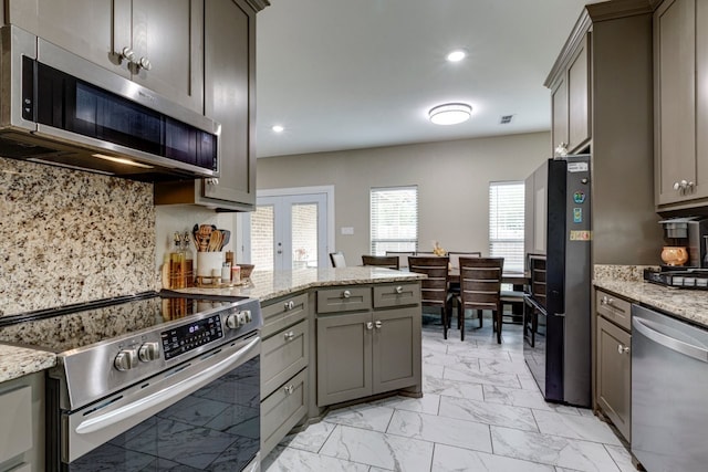 206 Willowbrook Ave, Tyler, TX 75702 - kitchen featuring stainless steel appliances, light marble finish floors, gray cabinets, a peninsula, and recessed lighting