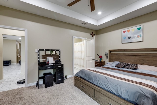 carpeted bedroom with connected bathroom and ceiling fan