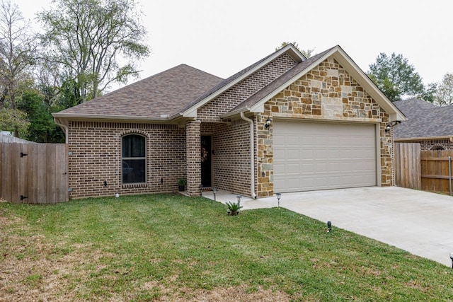 view of front of home with a front lawn and a garage