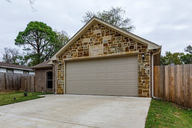 206 Willowbrook Ave, Tyler, TX 75702 - view of front of home with stone siding, concrete driveway, and a garage