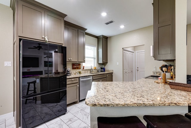 206 Willowbrook Ave, Tyler, TX 75702 - kitchen with dishwasher, light marble finish flooring, refrigerator, a peninsula, and recessed lighting