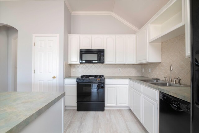 kitchen featuring sink, backsplash, white cabinetry, and black appliances