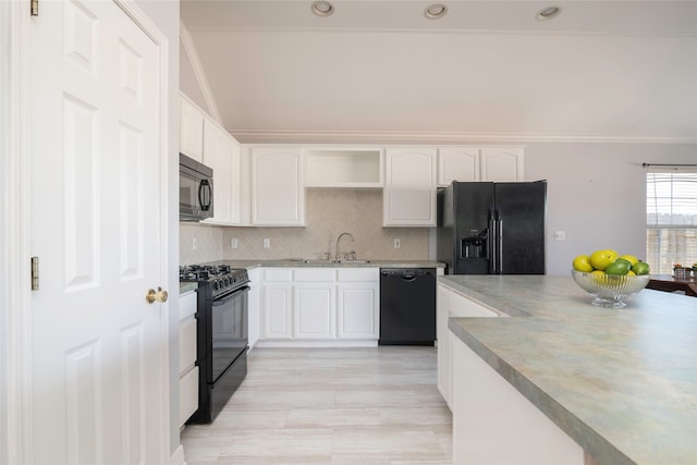 kitchen featuring black appliances, white cabinets, sink, ornamental molding, and tasteful backsplash