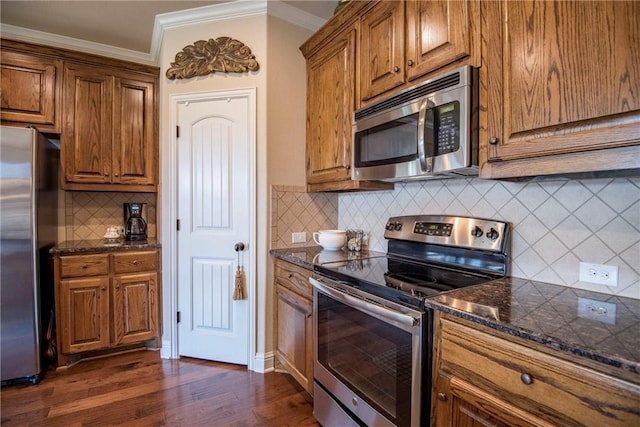 kitchen with decorative backsplash, dark hardwood / wood-style flooring, stainless steel appliances, and ornamental molding