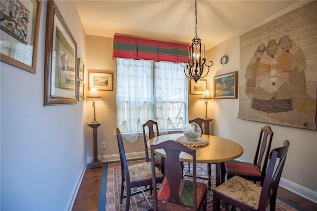 dining room featuring a notable chandelier and dark hardwood / wood-style flooring