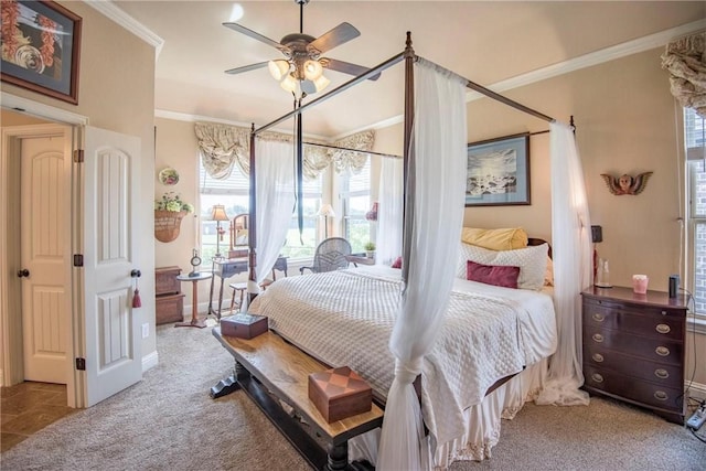 carpeted bedroom with ceiling fan and ornamental molding