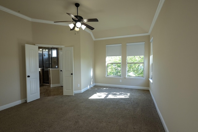 unfurnished bedroom with ceiling fan, ornamental molding, and dark colored carpet