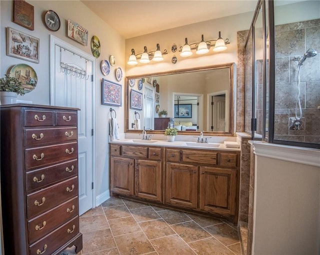 bathroom featuring a tile shower and vanity