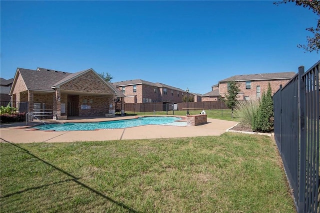 view of pool featuring a patio and a lawn