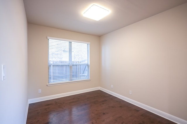 spare room featuring dark hardwood / wood-style flooring