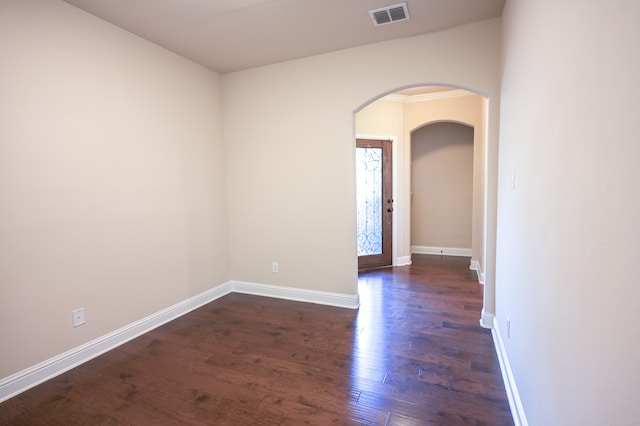 spare room with dark wood-type flooring