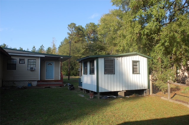 view of outbuilding featuring a yard and cooling unit