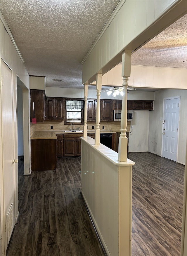 kitchen featuring dark brown cabinets, dark hardwood / wood-style flooring, a kitchen island, and ceiling fan