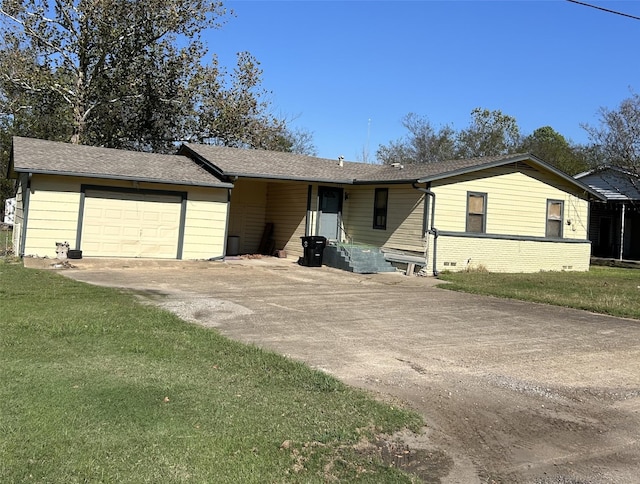 view of front of house with a front yard and a garage