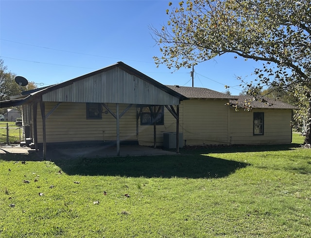 rear view of property featuring a patio area and a lawn