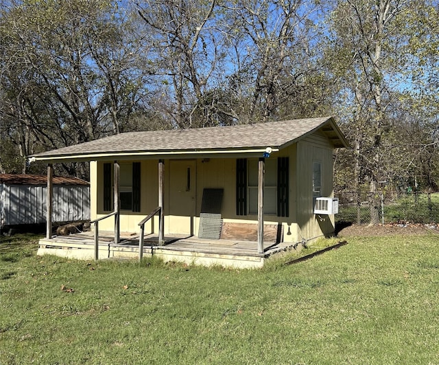 view of front of property with cooling unit and a front yard