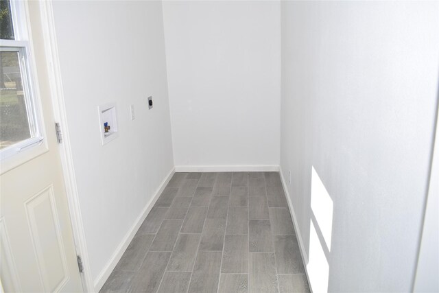 laundry room with hardwood / wood-style flooring, electric dryer hookup, and hookup for a washing machine